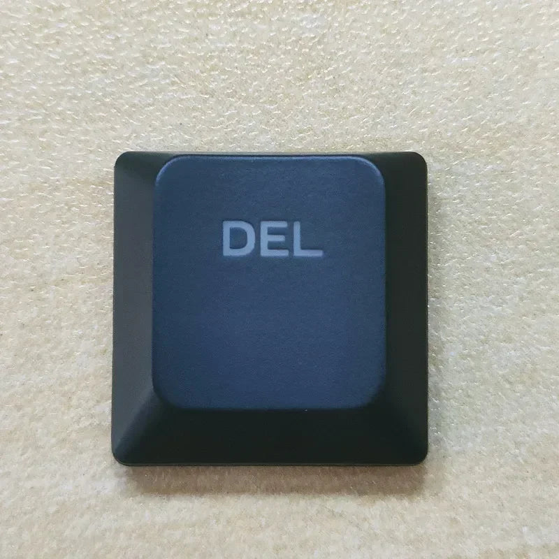 A dark blue replacement keycap labeled DEL for a Dell Alienware keyboard.