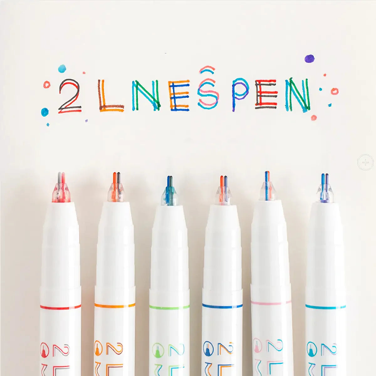 A collection of six dual-color line marker pens arranged in a row against a white background.