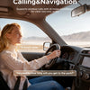 A woman is driving a car, looking out the window. The interior shows a dashboard and steering wheel.