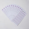 A stack of purple and white budget sheets for an A6 planner binder with envelope pockets
