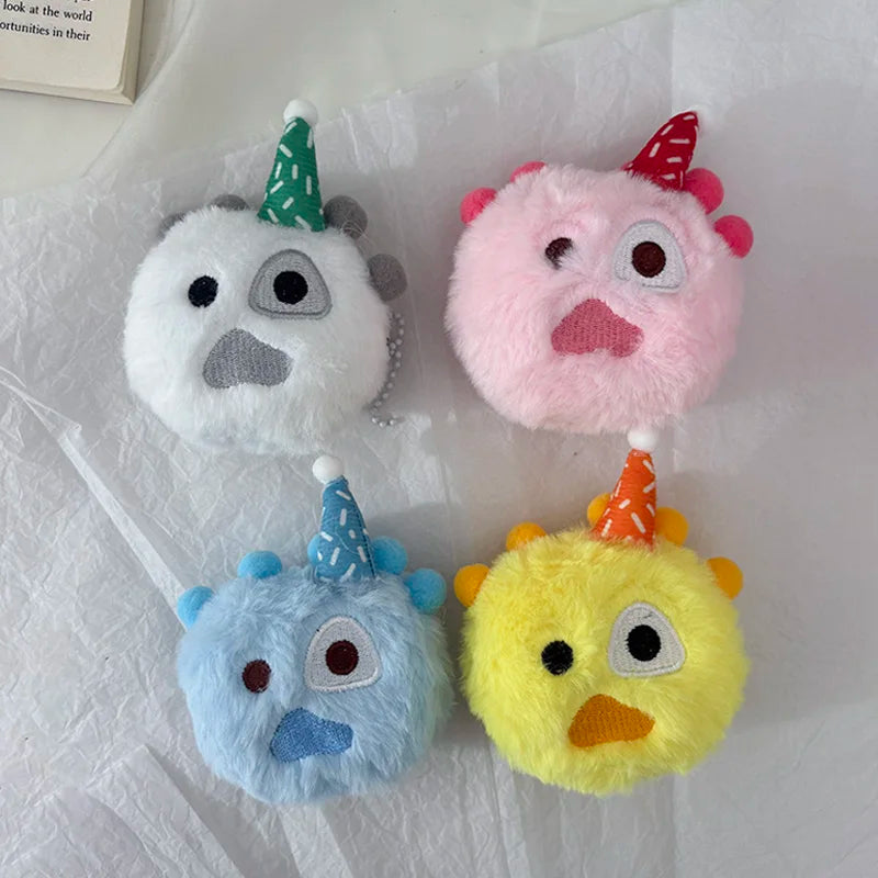 Four plush toys with conical hats in white, pink, blue, and yellow colors