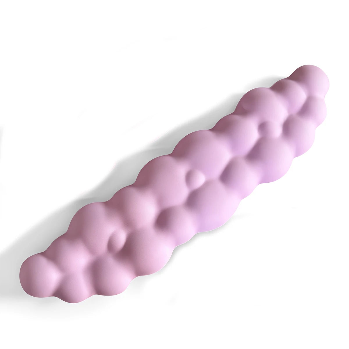A light purple ergonomic memory foam wrist rest pad shaped like a curved finger for desk use.