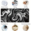 Large gaming mouse pad featuring a black and white liquid wave design used for typing, writing, and thermal insulation.