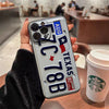A phone case designed like a Texas license plate featuring the state flag and text on an iPhone.