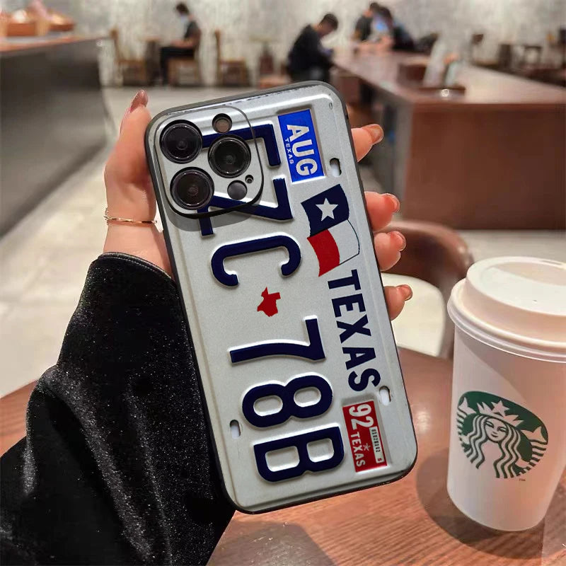 A phone case designed like a Texas license plate featuring the state flag and text on an iPhone.