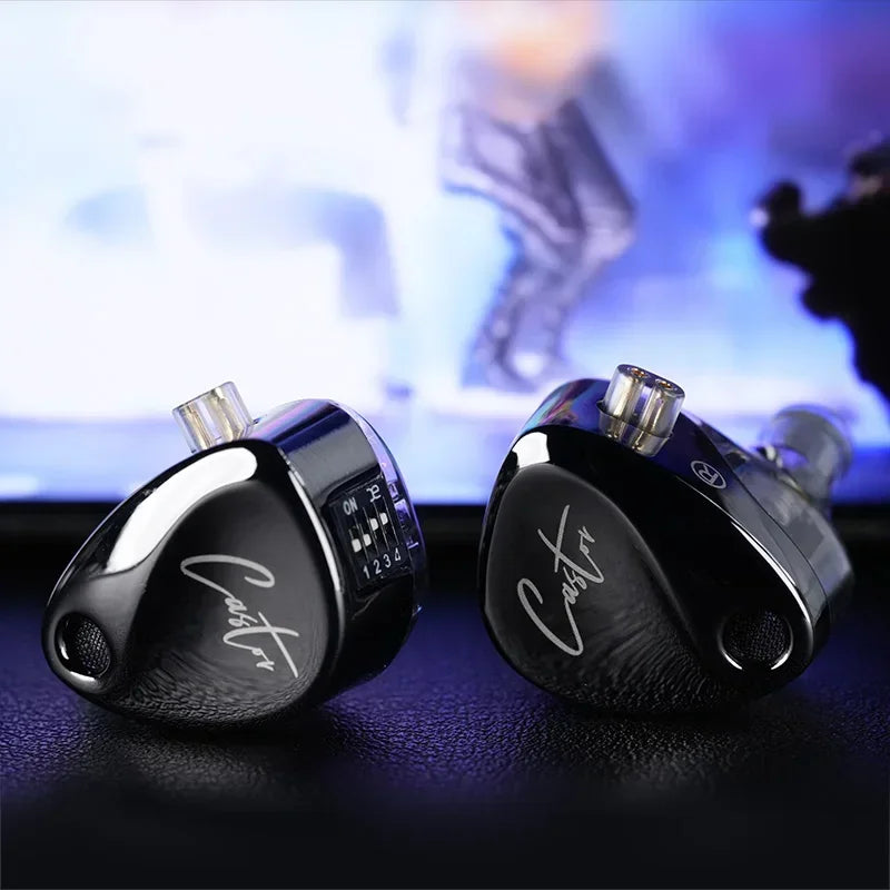 A pair of black KZ Castor 2DD dual dynamic driver earphones resting on a dark surface.