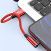 A red braided Lightning cable connects an iPhone to a Magic Keyboard for fast charging.