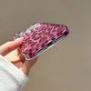 A hand holds a glamorous leopard print sequin shockproof phone case for an iPhone.