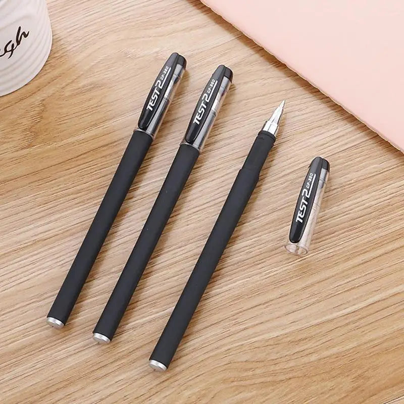 A pack of black gel ink pens with silver accents lying on a light wooden surface.