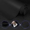 Black extra large anti-slip rubber mouse pad rolled up on a dark surface with close-ups showing texture and grip