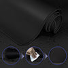 Black extra large anti-slip rubber mouse pad rolled up on a dark surface with close-up views of the texture