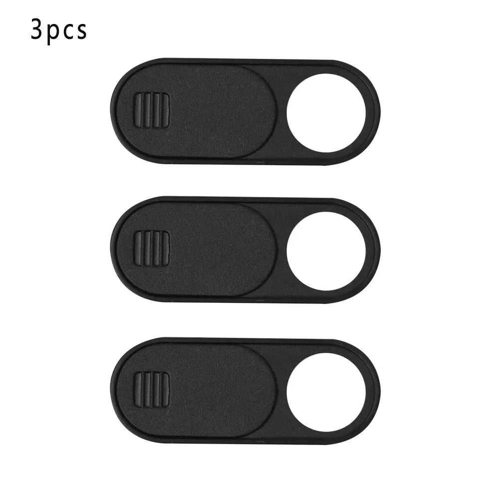 Three black slim camera sliders or privacy covers shown side by side