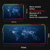 An RGB backlit gaming mouse pad featuring a glowing map of the world on a large surface.