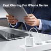 A person is using a 30W USB-C fast charger with a Lightning cable to charge an iPhone, with a laptop nearby.