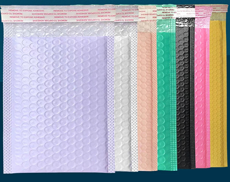 A row of purple padded bubble mailers in various colors including white, pink, black, and yellow.