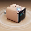 A beige smart display charger device with a black screen and blue indicator light, shown on a smooth surface.