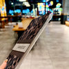 A protective case with a leopard print design for an iPad, shown diagonally in a blurred indoor setting.
