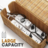 A handwoven rattan cable management box with a lid containing white power strips and cables.