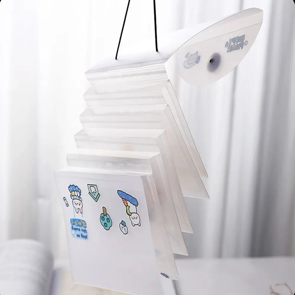 A stack of transparent storage books for stickers and documents hanging on a rack.