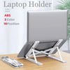 A silver laptop holder with adjustable arms is shown on a wooden desk.