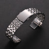 A stainless steel watch band with a folding safety clasp shown on a dark background.
