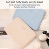 A light pink laptop sleeve is shown resting on a white surface next to a blue striped sleeve.
