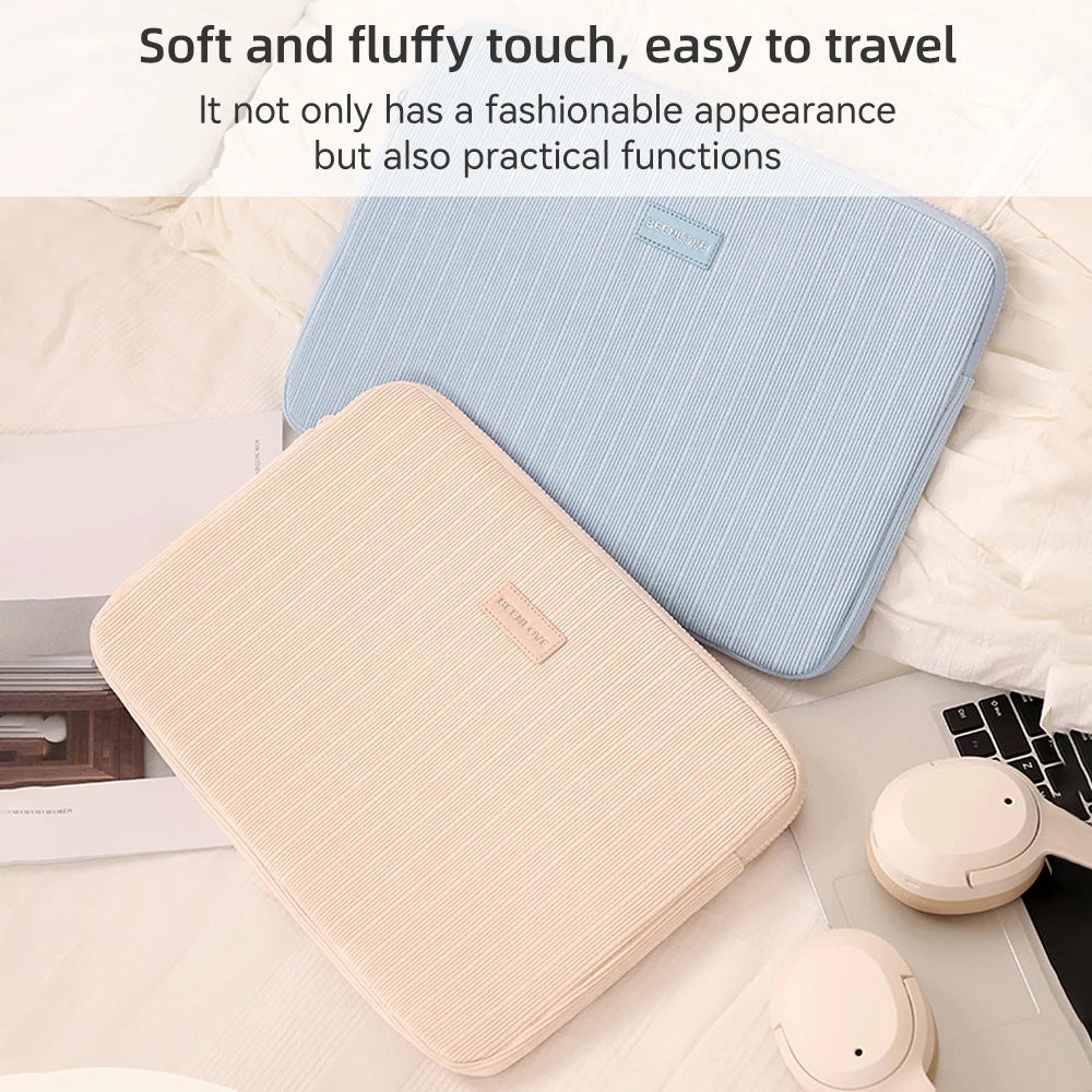 A light pink laptop sleeve is shown resting on a white surface next to a blue striped sleeve.