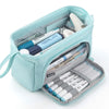 A light blue canvas pencil case with a zipper containing various pens and markers.