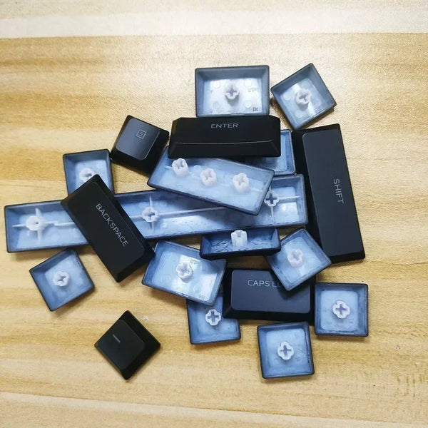 A collection of replacement keycaps for a keyboard, including enter, shift, and backspace keys.