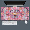 A vintage Persian rug patterned gaming mouse pad with a non-slip rubber base, positioned under a computer monitor.