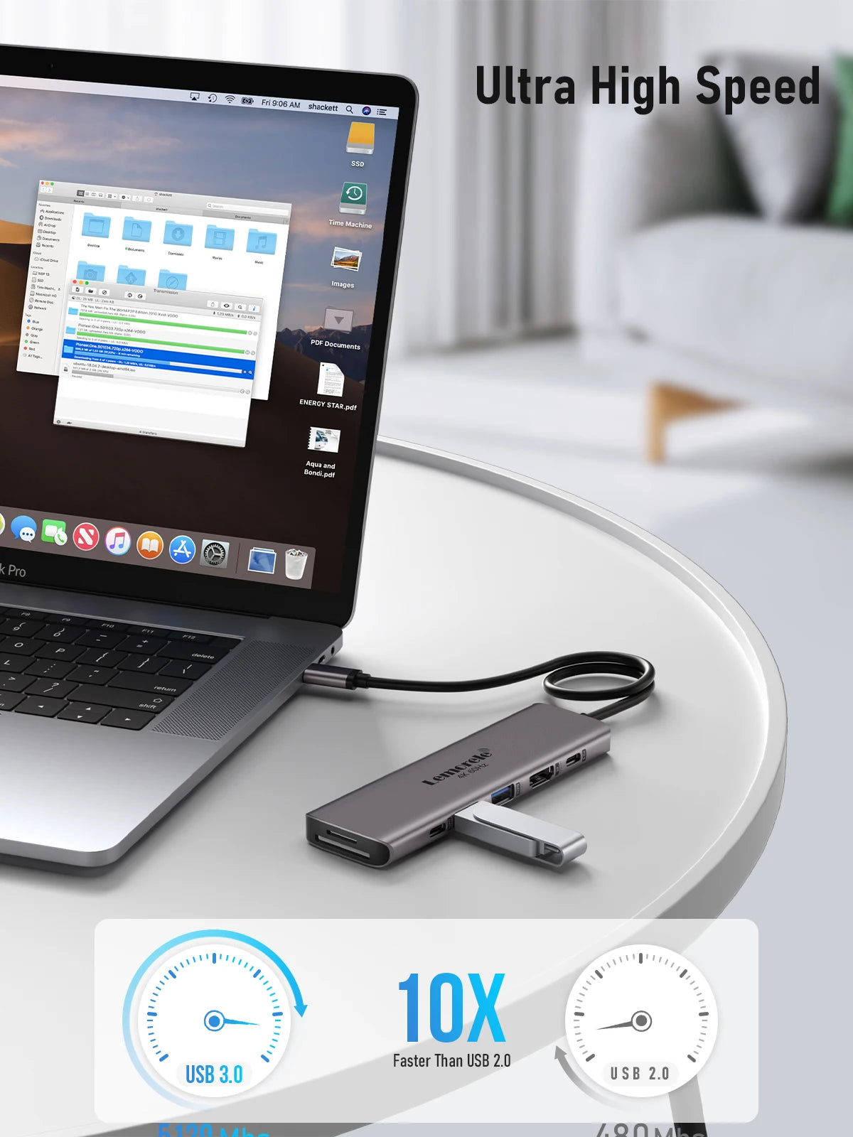 A silver 7-in-1 USB-C docking station is shown next to a laptop, demonstrating its high-speed connectivity features.