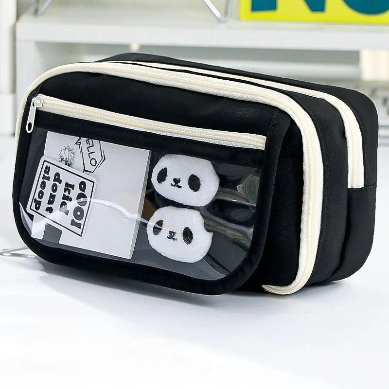 Black pencil case with a transparent flip pocket displaying two white panda-shaped items.