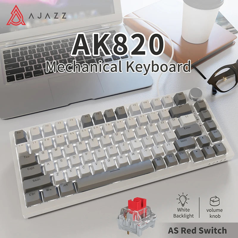 A white mechanical keyboard with gray keycaps and a red switch is shown next to a laptop.