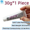 Tube of GD370 thermal grease paste with a hand holding it, showing its packaging and net weight.