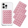 A white phone case and a pink silicone suction cup mount with multiple circular suction cups.