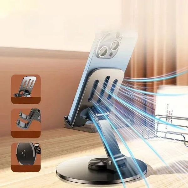 A silver mobile phone holder with a rotating base and multiple grips is shown on a wooden surface.
