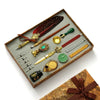 A luxury fountain pen set with a wax seal kit displayed in a wooden tray.