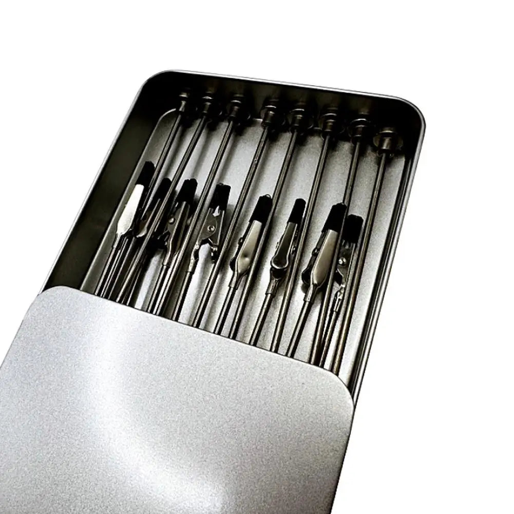 A silver magnetic painting stand holding multiple paintbrushes in a tray.