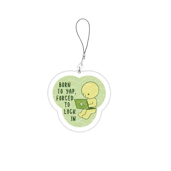 A clear acrylic charm shaped like a smiling yellow face with text that reads Born to yap forced to lock in