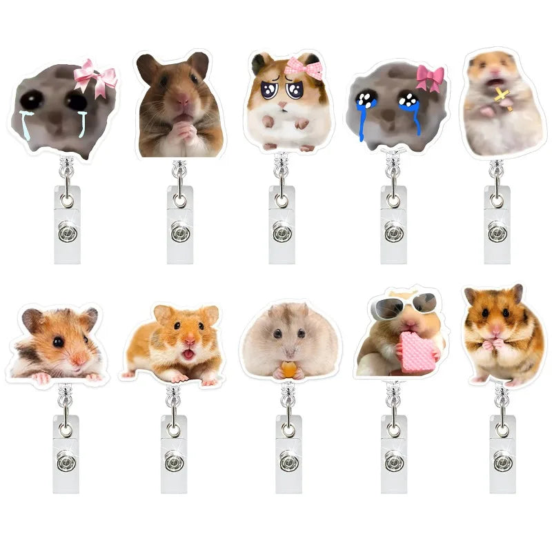 A collection of acrylic badge reels featuring various funny hamster faces and expressions.