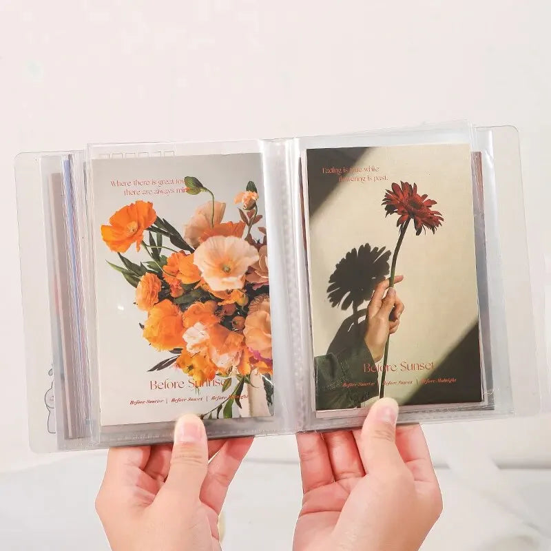 A set of clear photo storage booklets containing floral and sunset themed photographs.