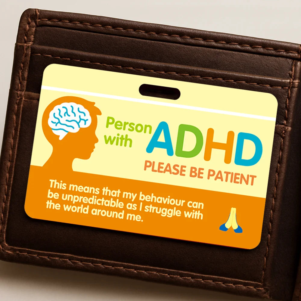A brown leather card holder displaying an ADHD awareness card with text encouraging patience.