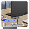 A silver adjustable adapter for monitors, showing its fit and stability on a wooden desk.