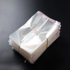 A stack of 100 self-sealing transparent plastic bags for jewelry, candy, and gifts.