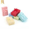 A set of four jewelry gift boxes in pink, red, blue, and green colors with ribbon accents.