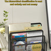 A black metal mesh desk file organizer holding various paper and planner items.
