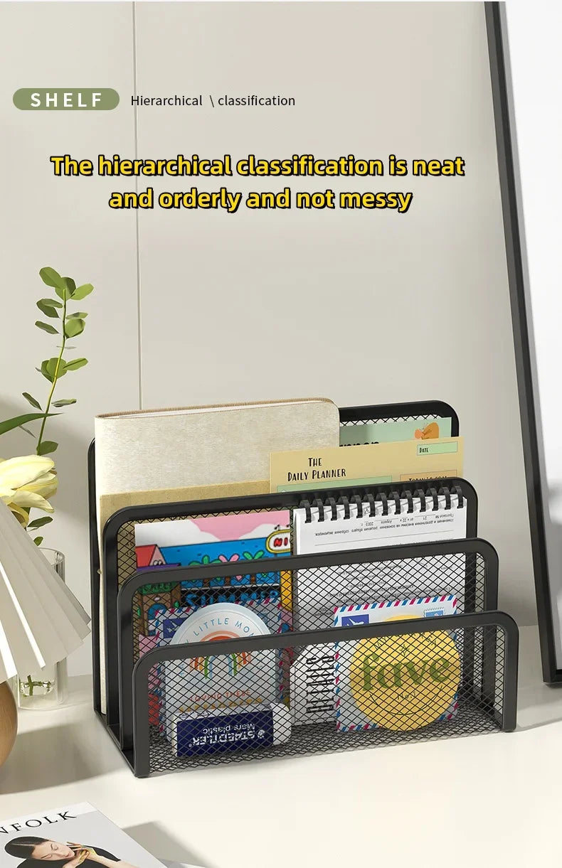 A black metal mesh desk file organizer holding various paper and planner items.