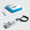 A packing list showing a silver USB-C hub, a black cable, a blue product box, and a user manual.