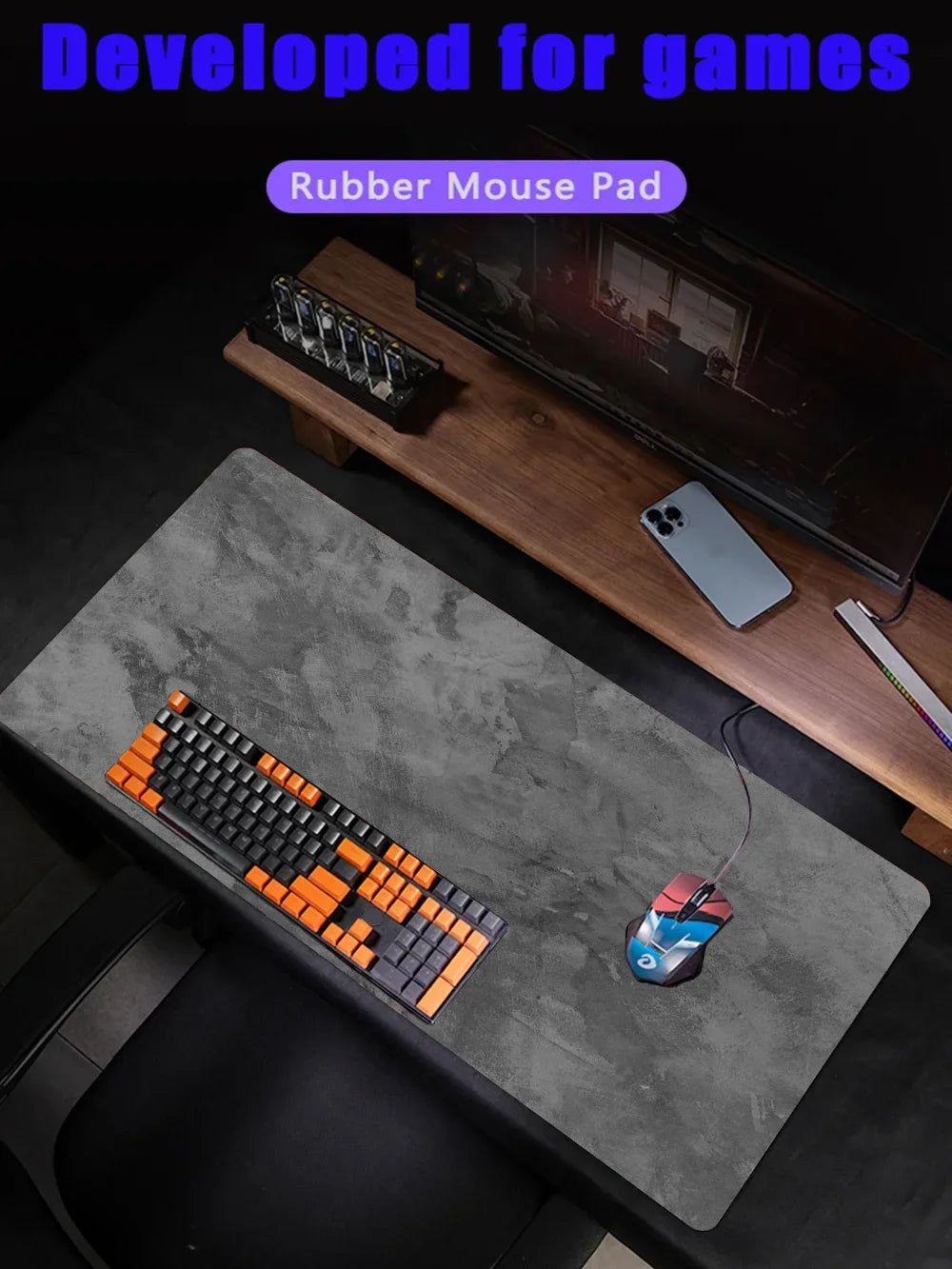 Gray overlocked mouse pad with a keyboard, mouse, and smartphone on a wooden desk.