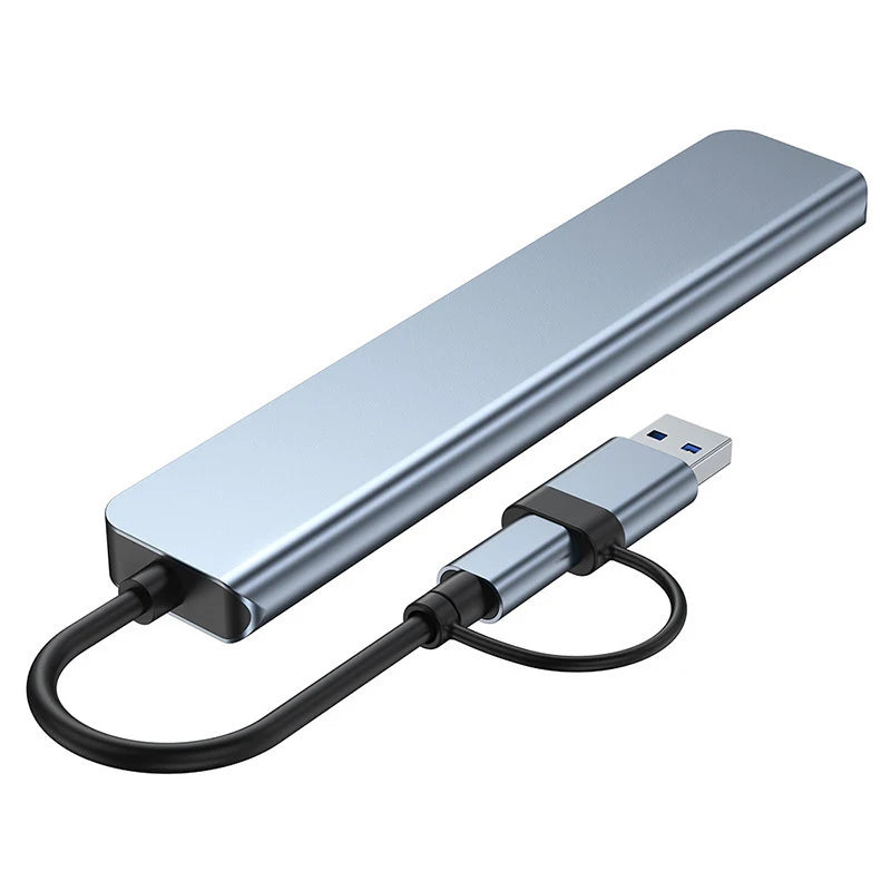Silver multi-port USB-C hub adapter with a cable and audio jack.